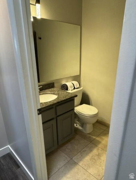 Bathroom with vanity, toilet, and tile patterned floors