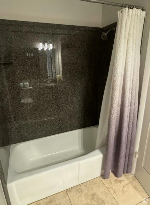 Bathroom featuring tile patterned flooring and shower / tub combo