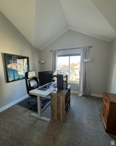 Carpeted office with lofted ceiling