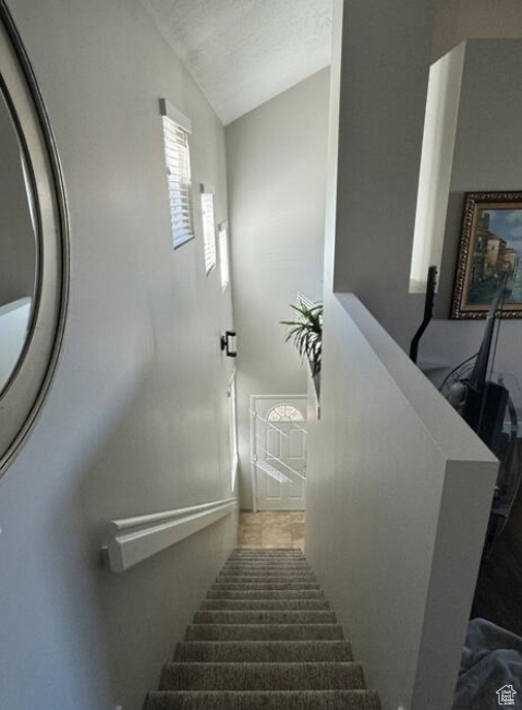 Staircase with lofted ceiling