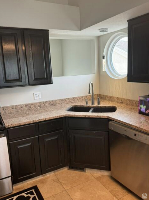 Kitchen with sink, light tile patterned floors, and dishwasher