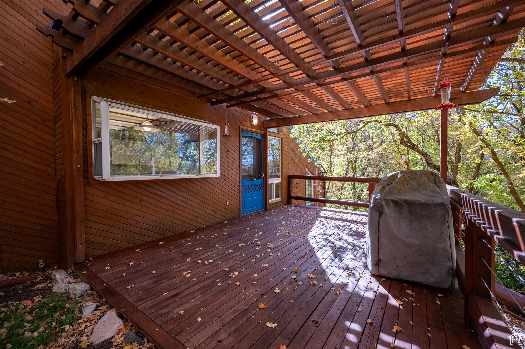 Deck featuring area for grilling and a pergola