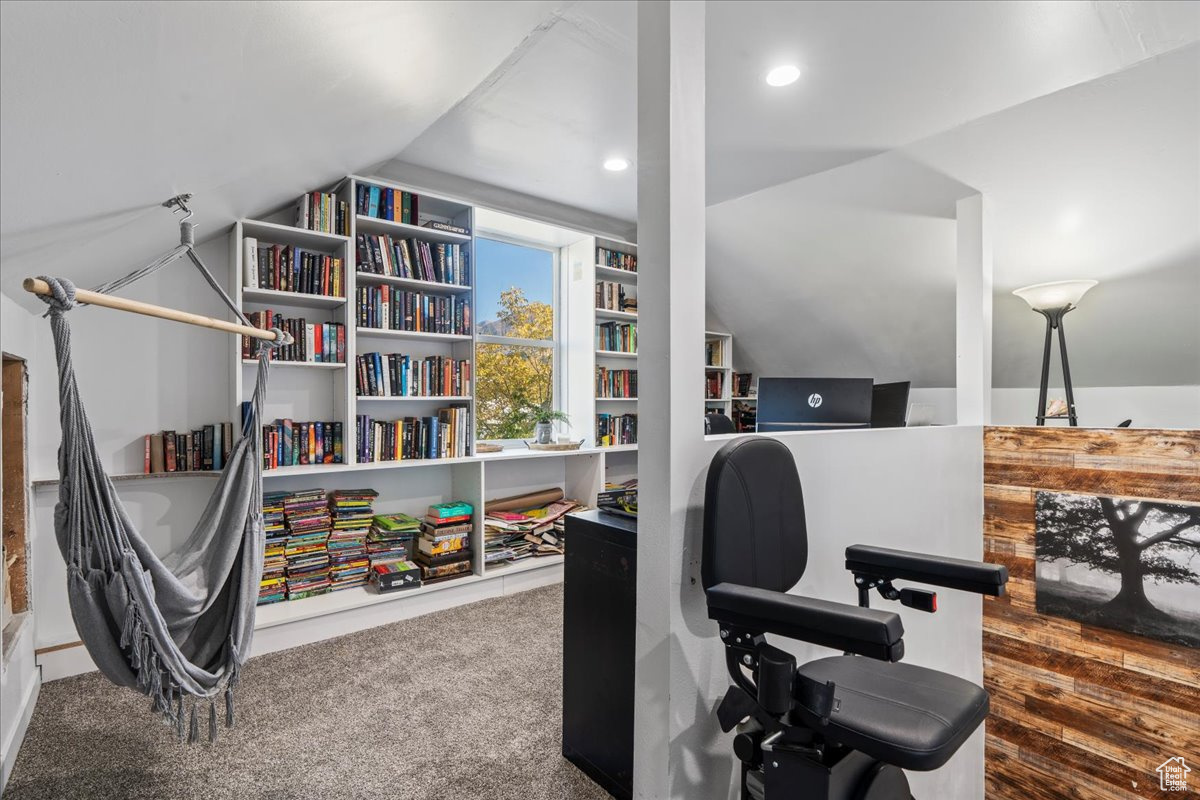 Office area with carpet flooring and vaulted ceiling