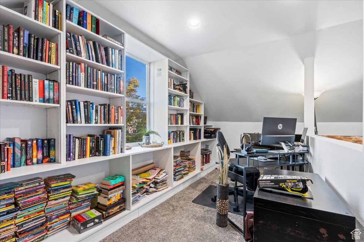 Office with lofted ceiling and carpet