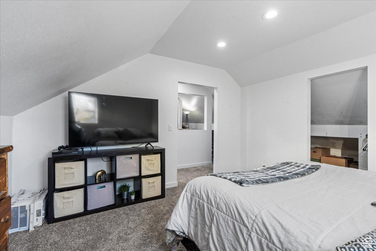 Carpeted bedroom with vaulted ceiling