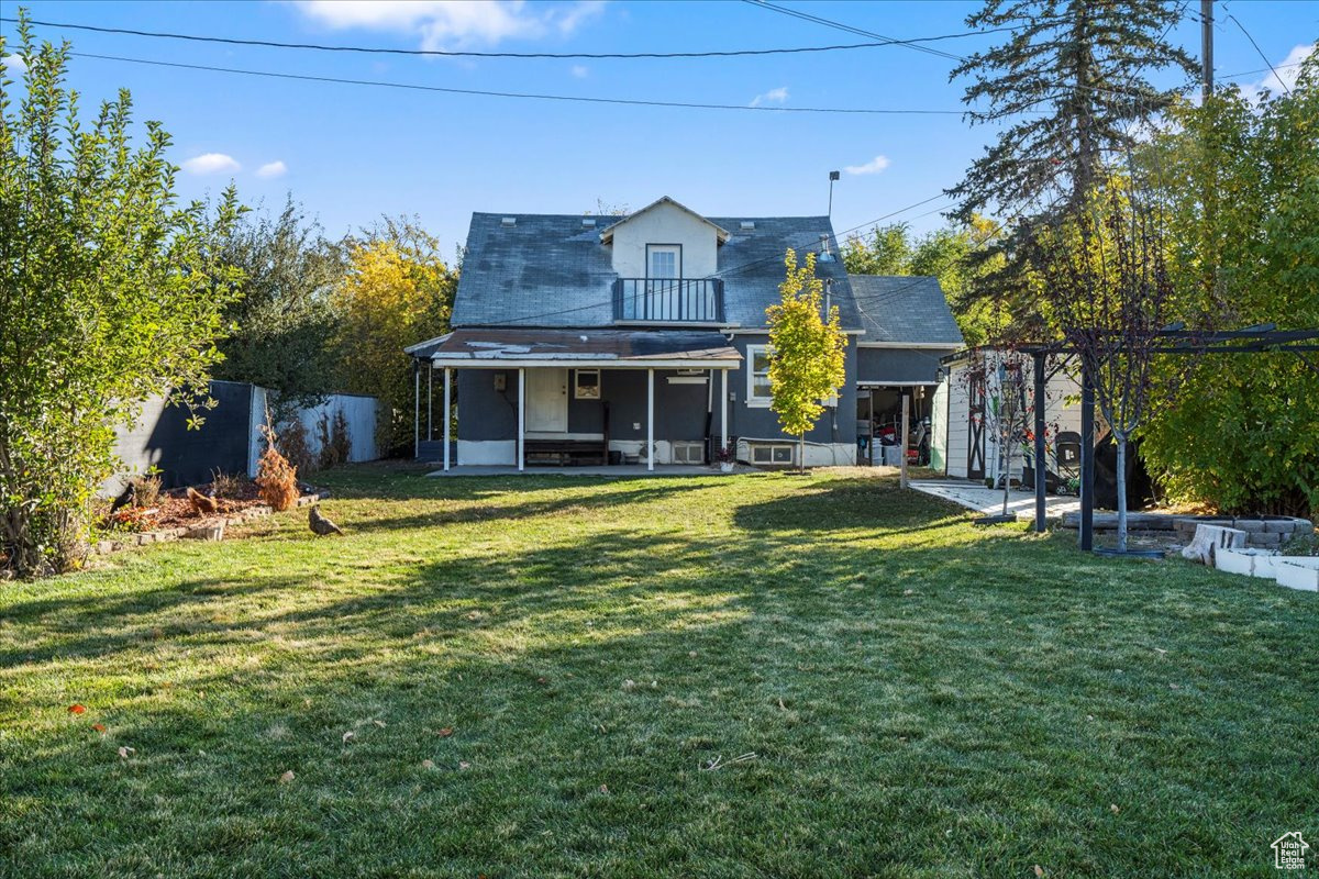 Rear view of house with a lawn