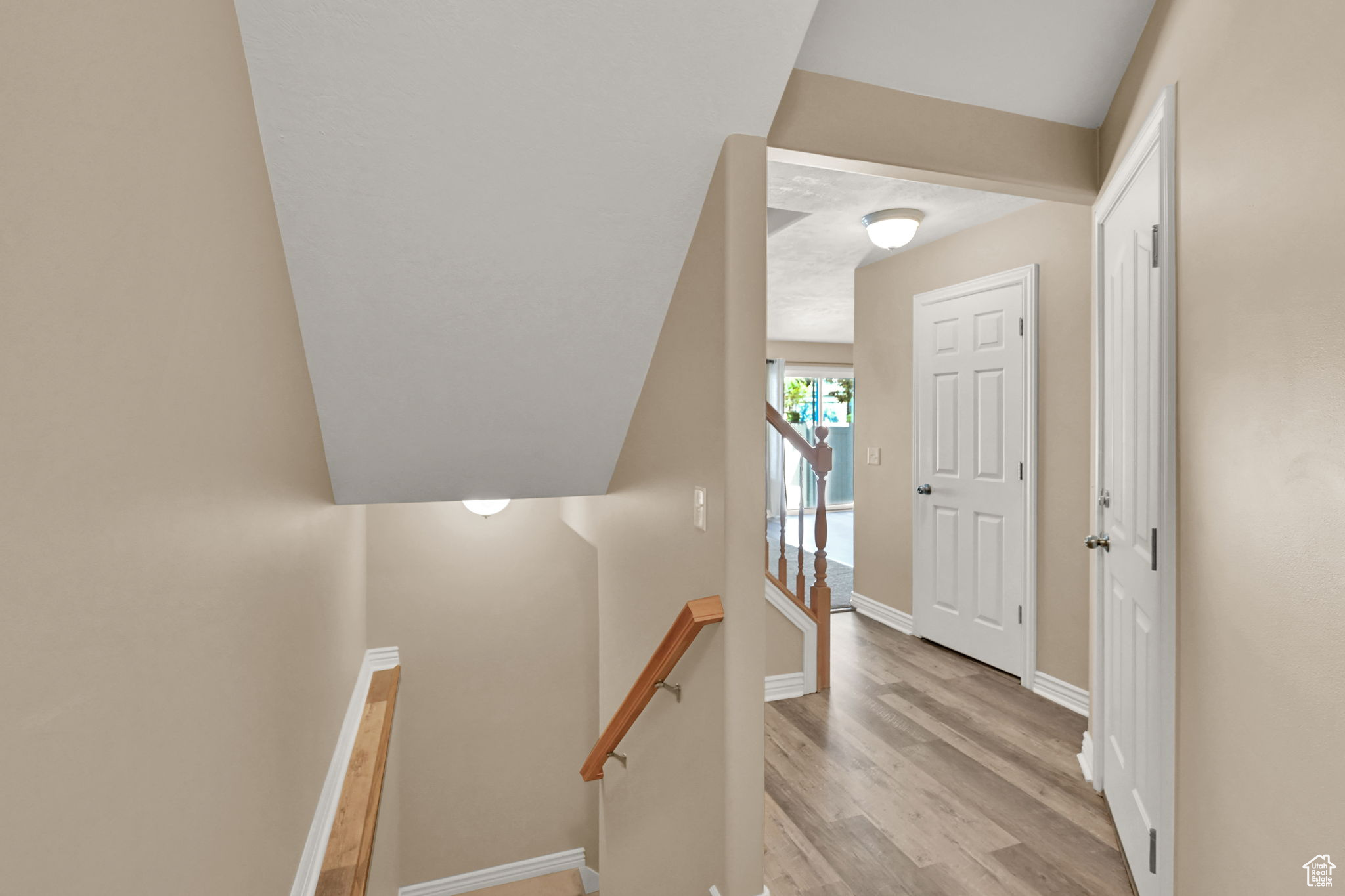 Stairway with hardwood / wood-style flooring