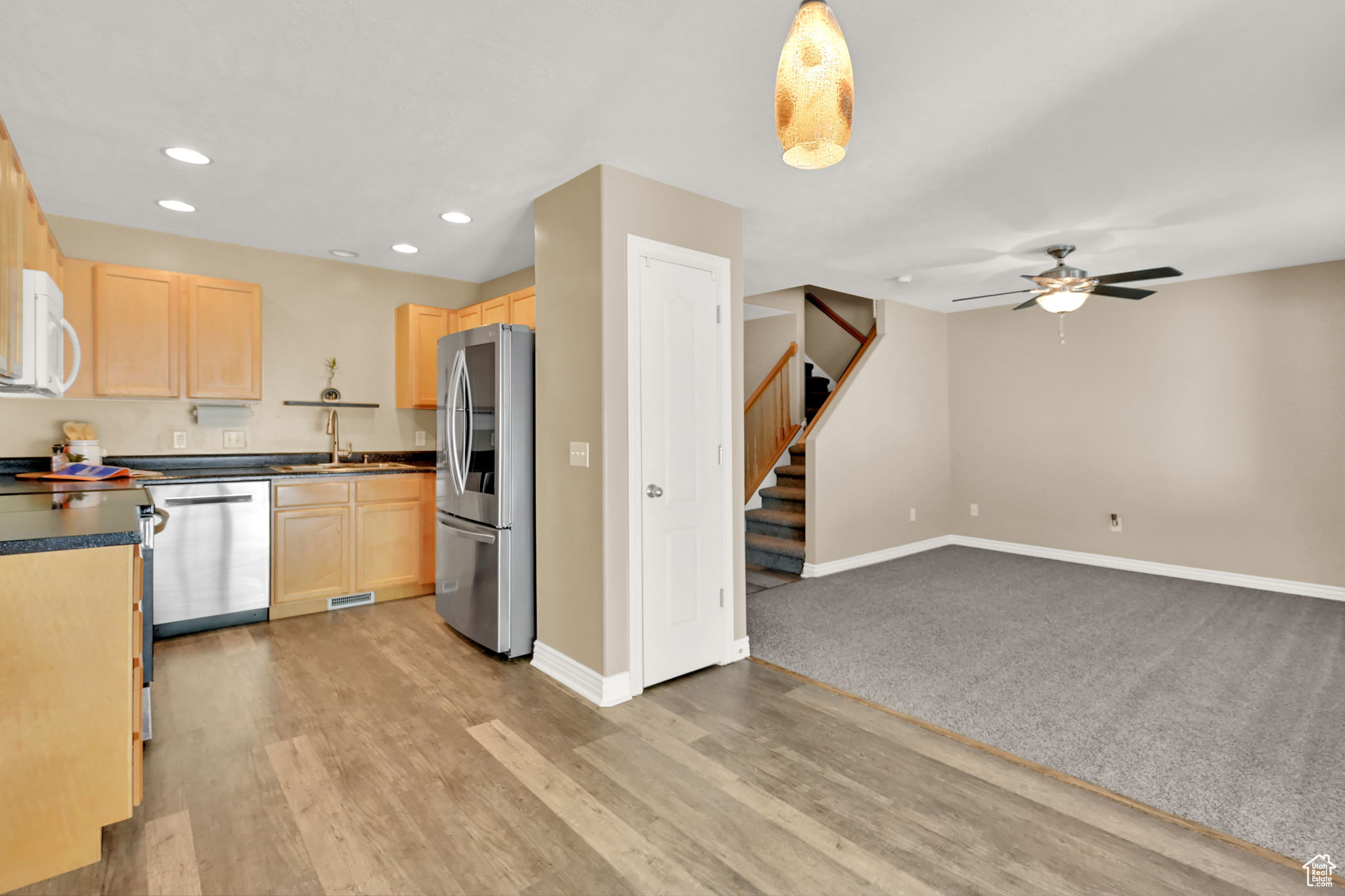 Kitchen with sink, appliances with stainless steel finishes, light hardwood / wood-style flooring, and light brown cabinets