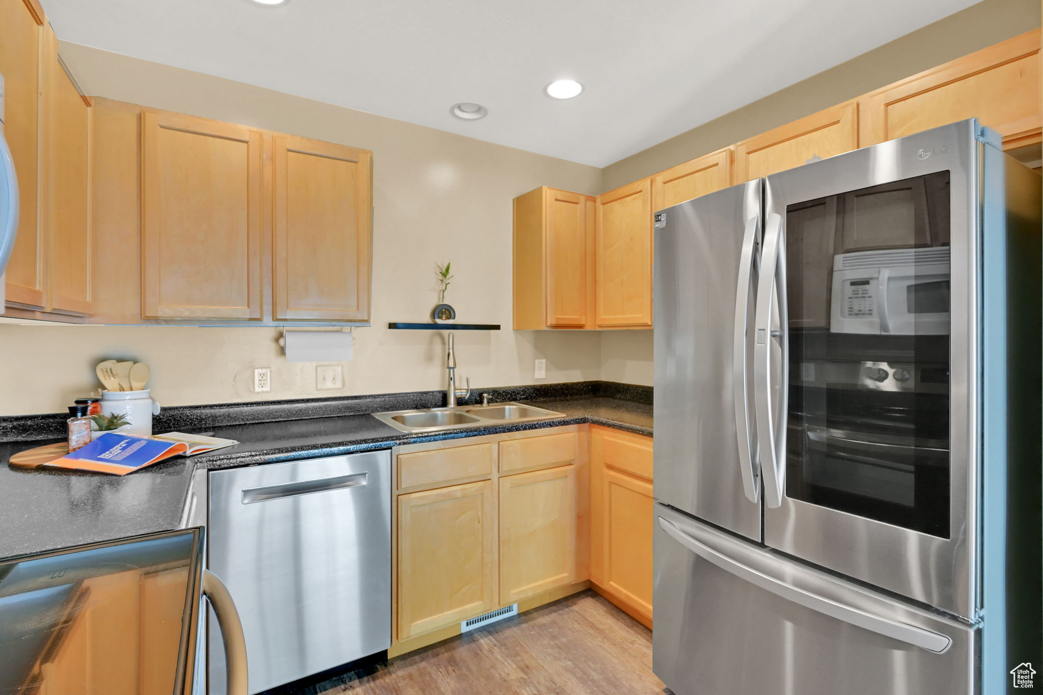 Kitchen featuring sink, appliances with stainless steel finishes, light hardwood / wood-style flooring, and light brown cabinets