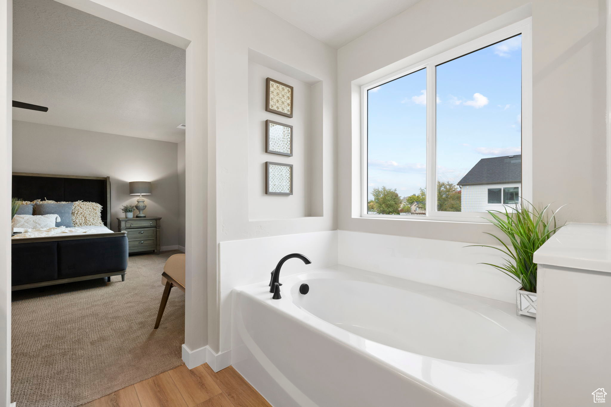 Bathroom with a bathing tub, vanity, and wood-type flooring