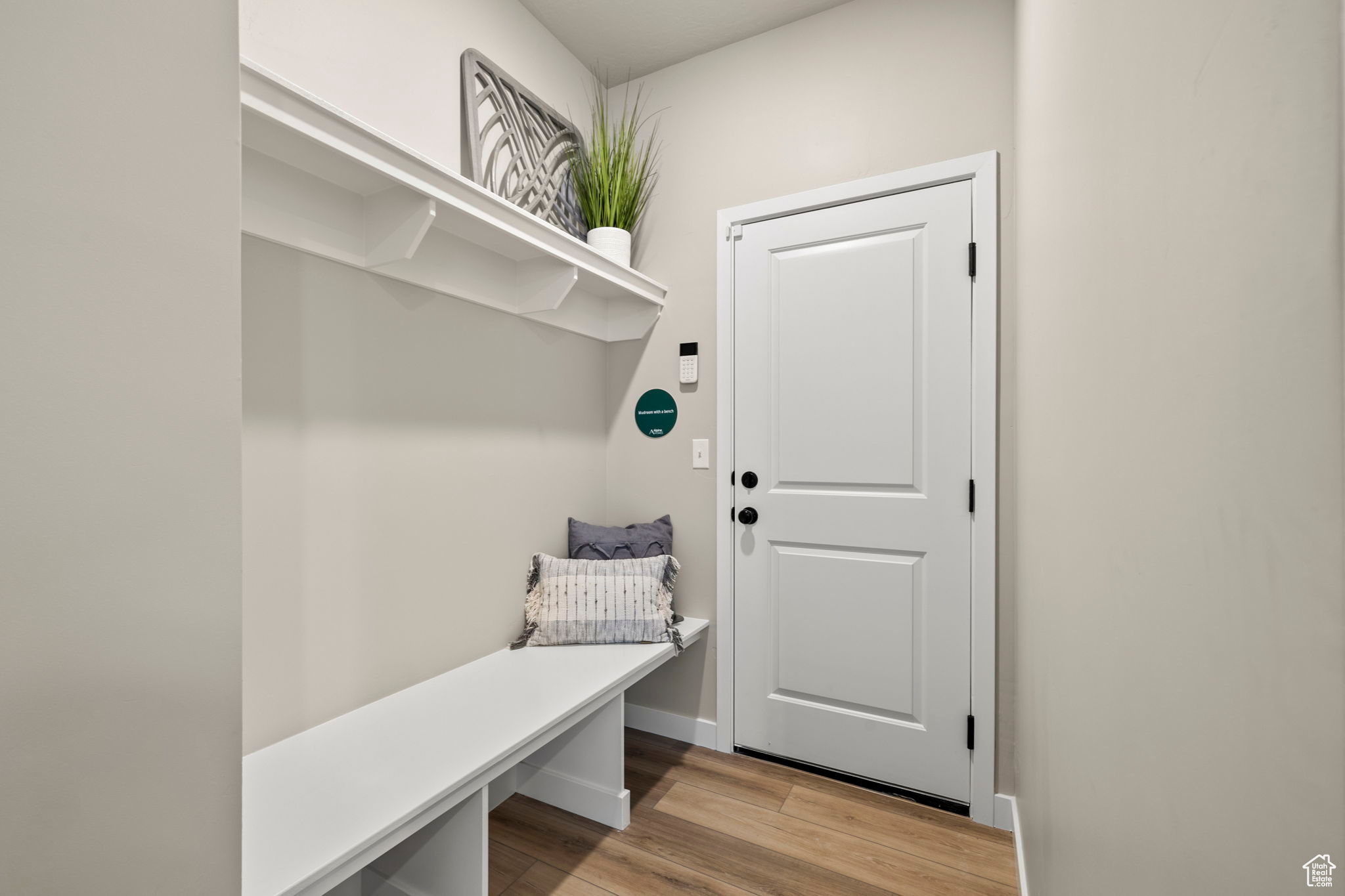 Mudroom with light hardwood / wood-style flooring