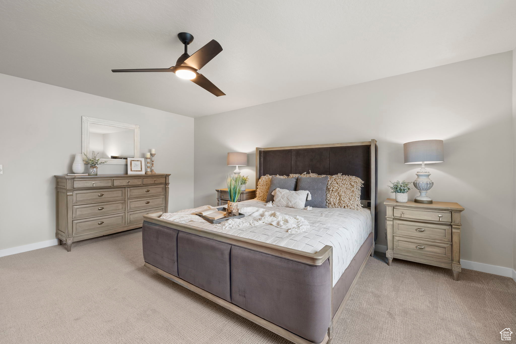 Carpeted bedroom with ceiling fan