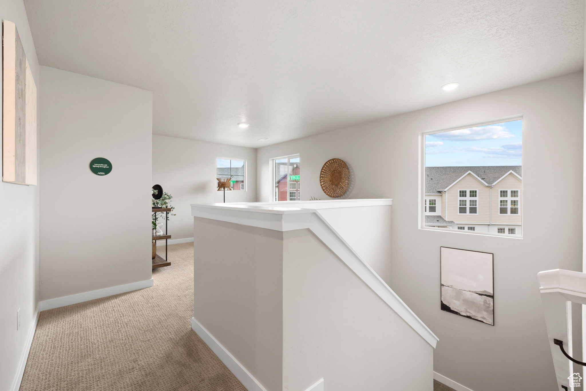 Hall with carpet flooring and plenty of natural light