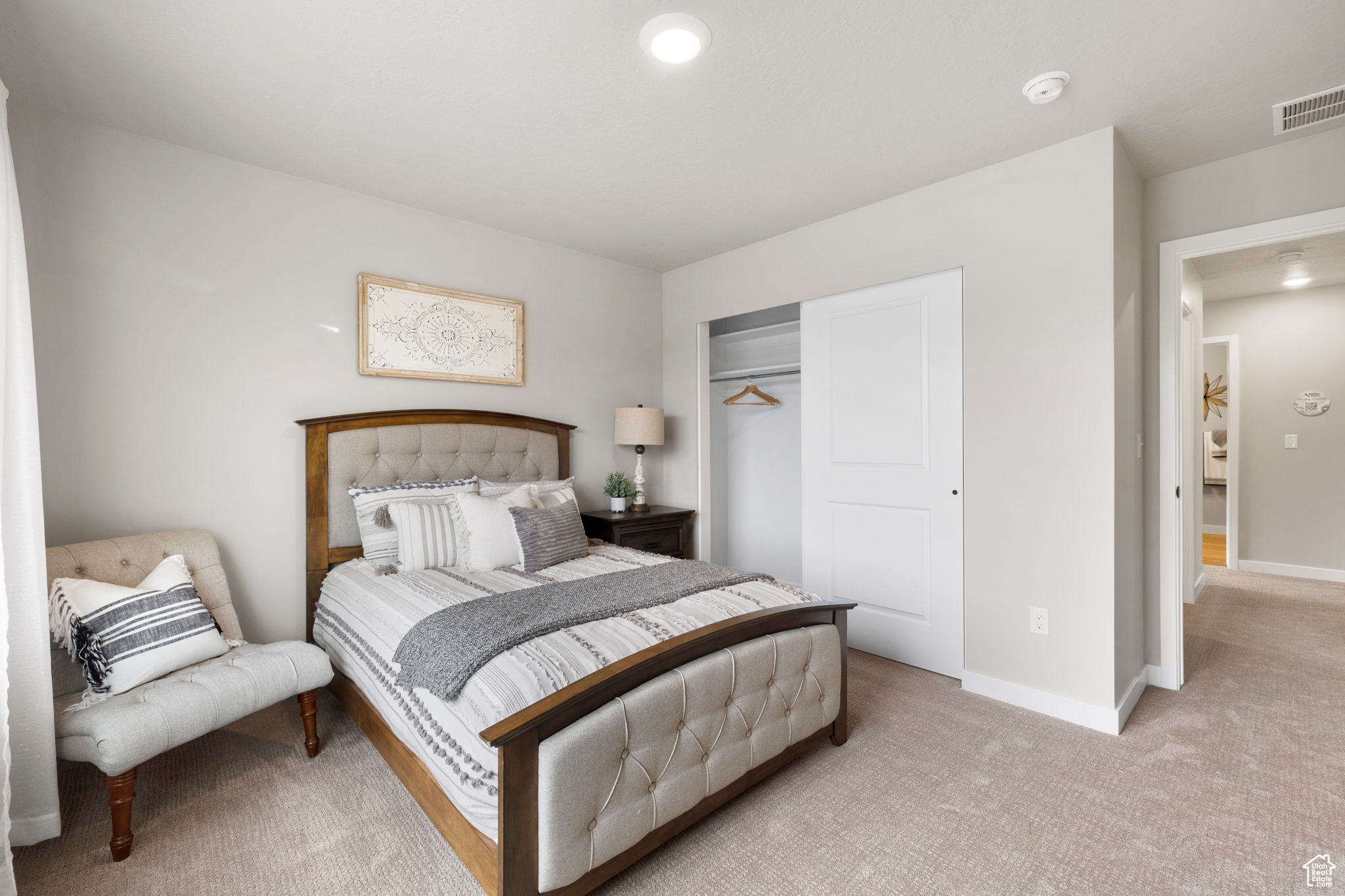 Carpeted bedroom featuring a closet