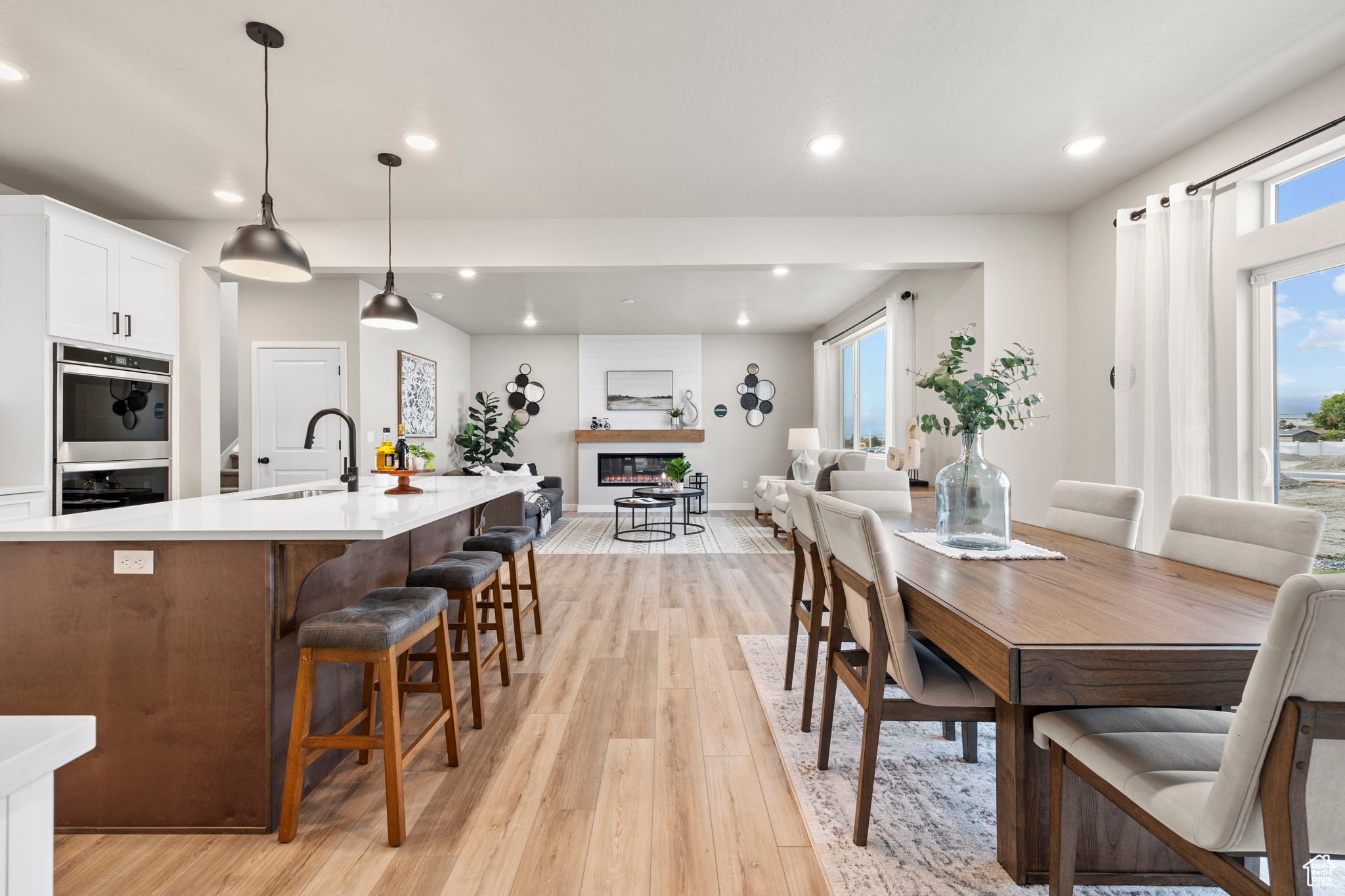 Dining room featuring light hardwood / wood-style flooring, sink, and a fireplace