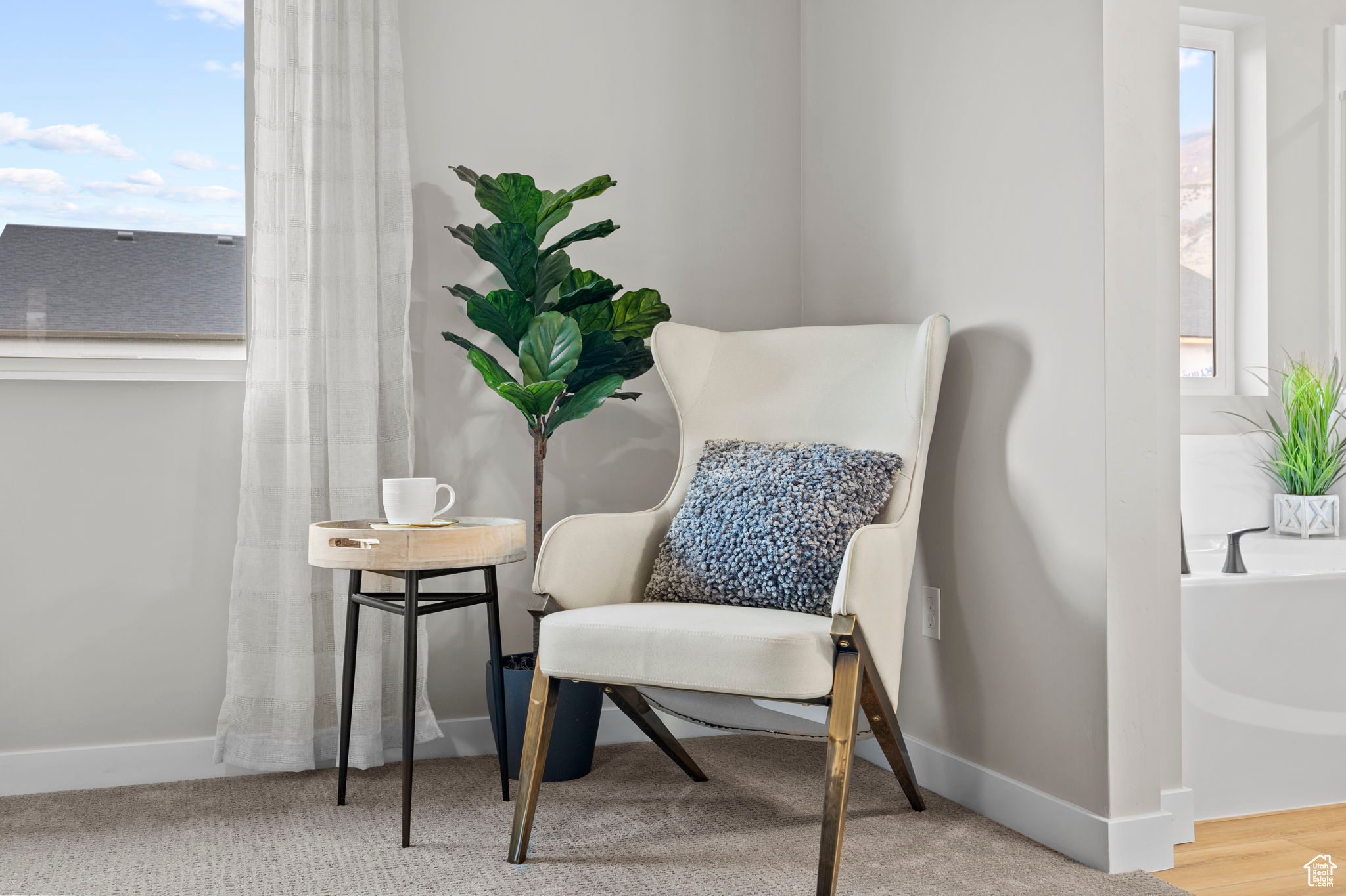 Sitting room with a healthy amount of sunlight and hardwood / wood-style floors