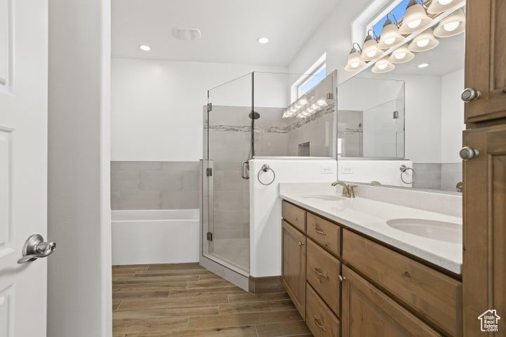 Bathroom featuring vanity, an enclosed shower, and hardwood / wood-style flooring