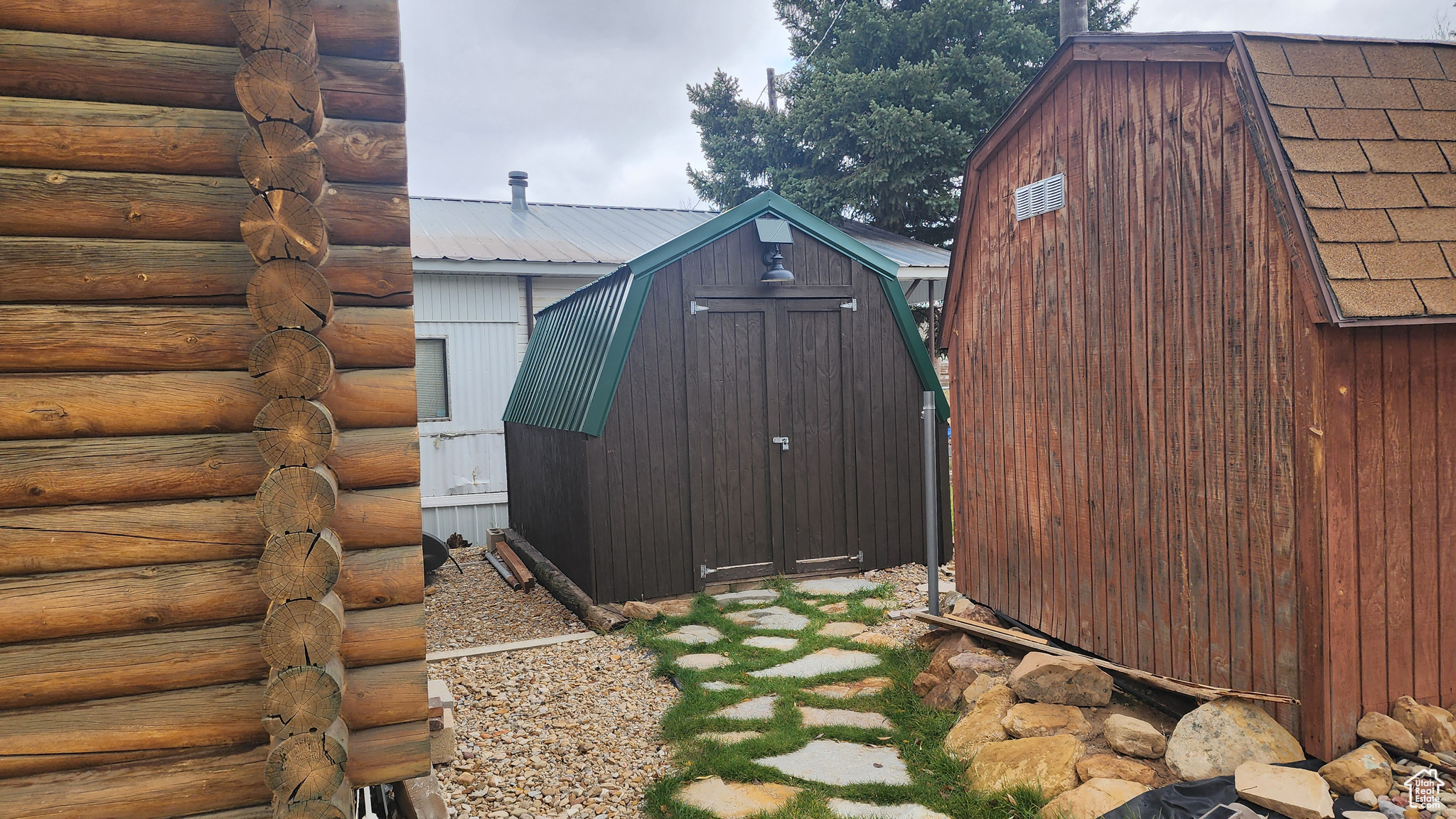 View of side of home with a shed