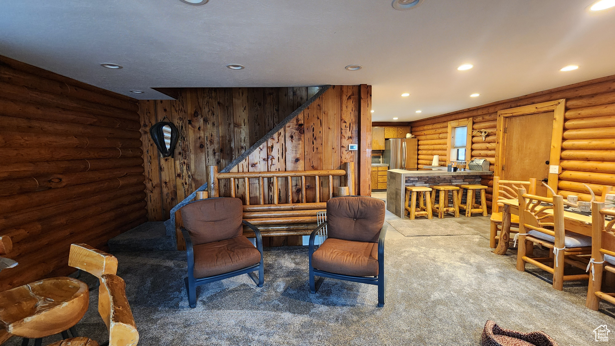 Interior space with carpet flooring and rustic walls