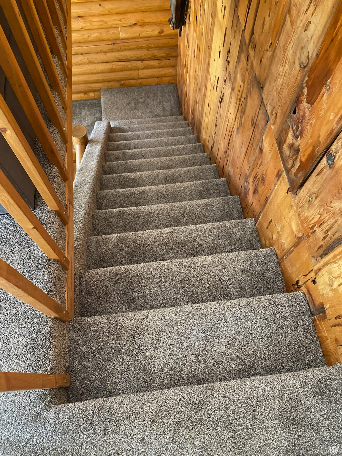 Staircase featuring carpet