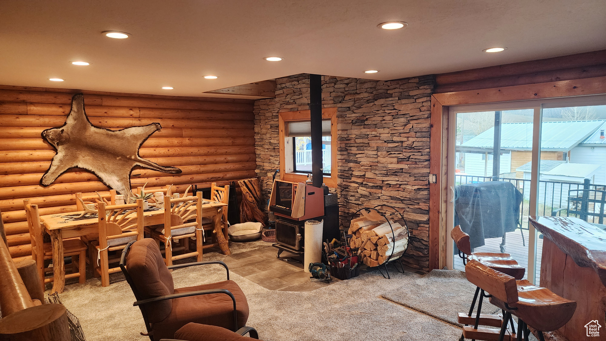 Living room featuring log walls and light carpet