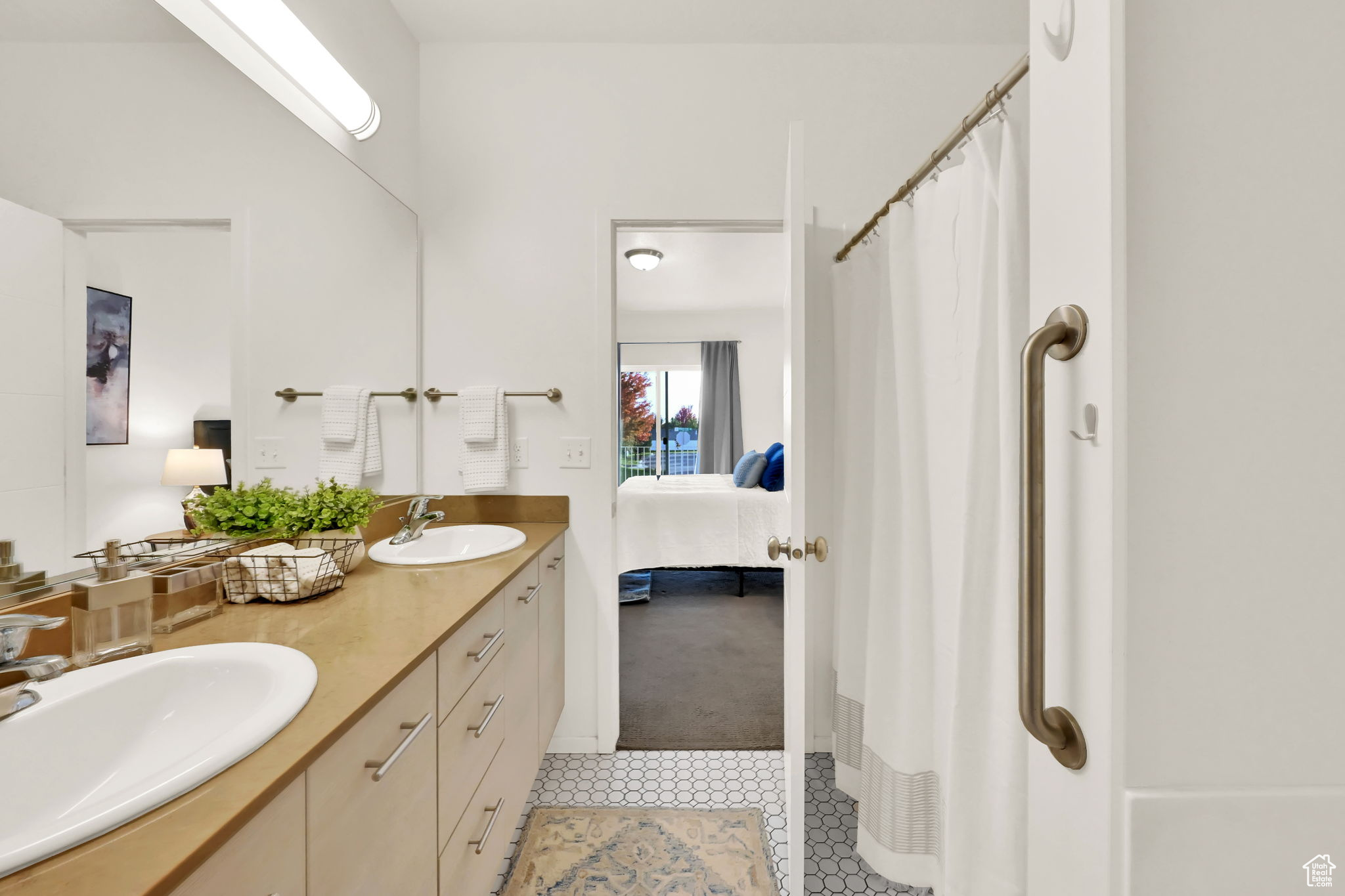 Bathroom with vanity, a shower with curtain, and tile patterned flooring