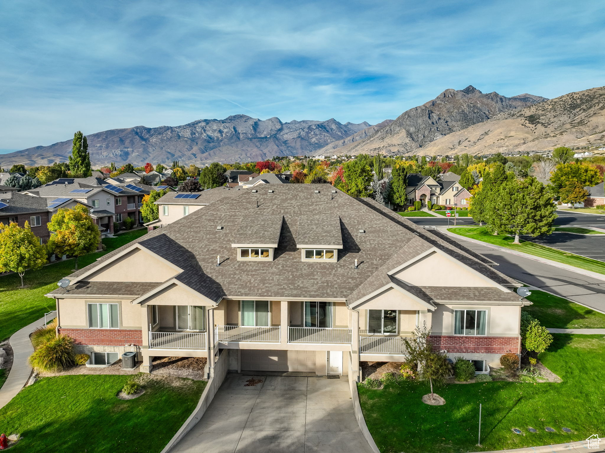 View of front of home featuring a mountain view and a front lawn