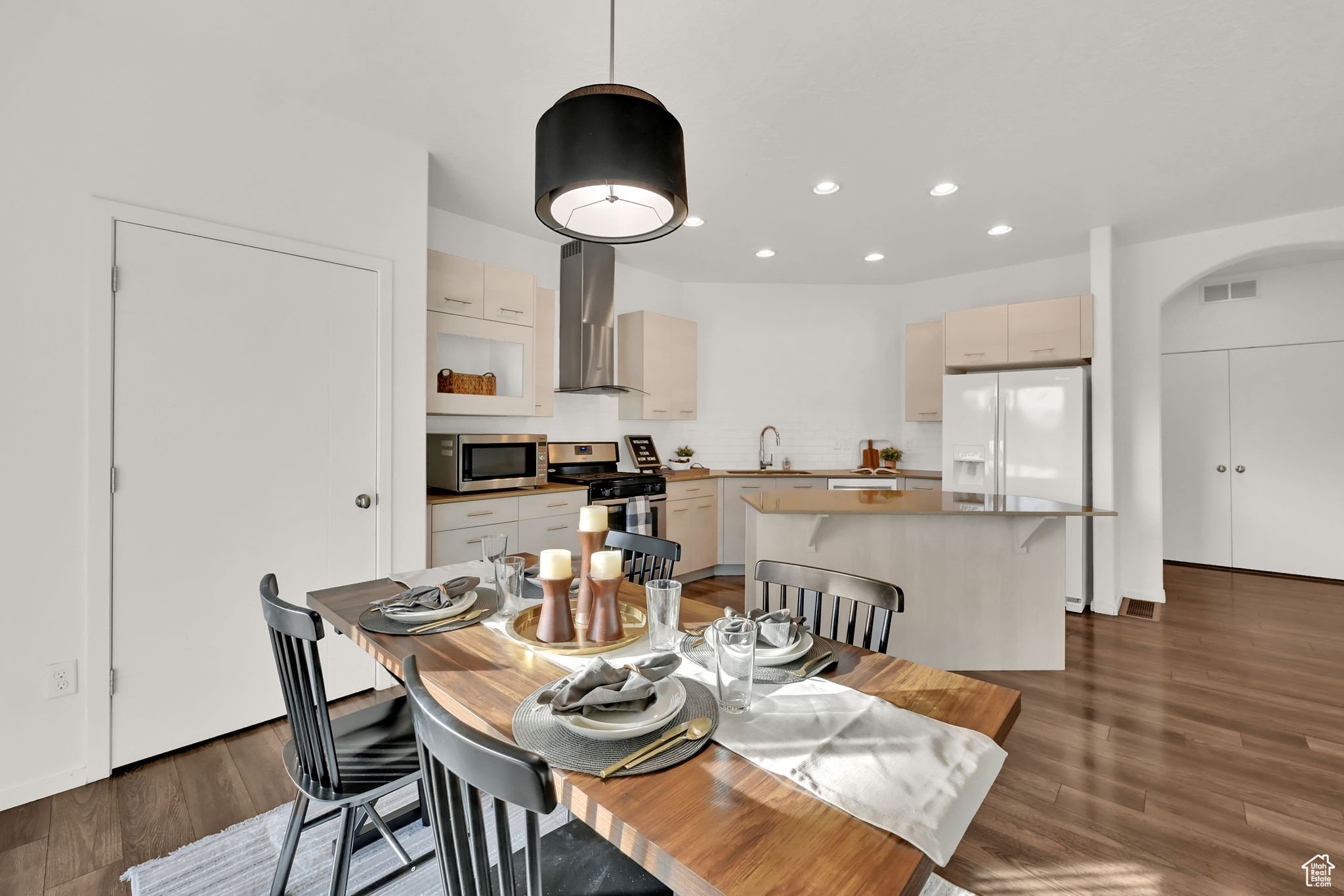 Dining area featuring sink and dark wood-type flooring