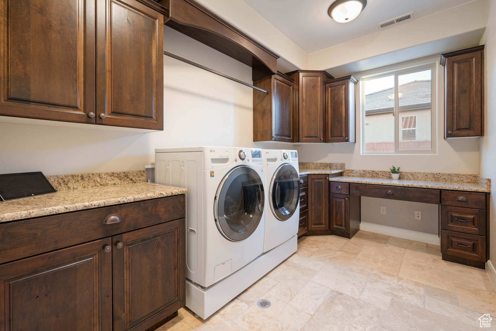 Laundry area featuring cabinets and independent washer and dryer