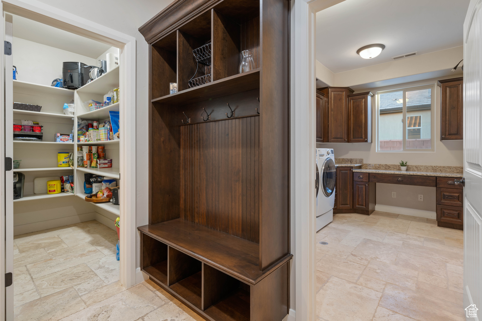 Mudroom featuring washer / dryer and built in desk