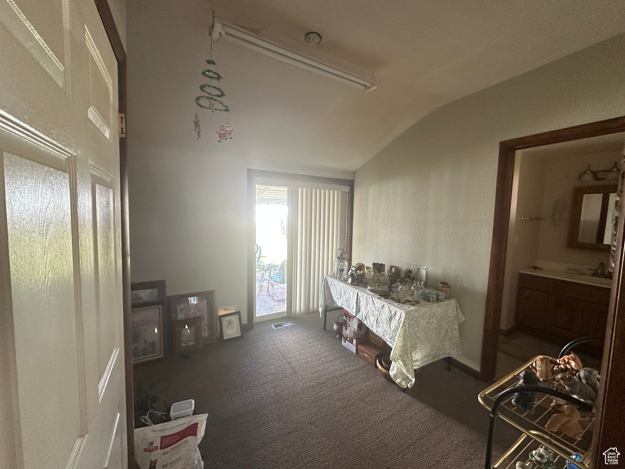 Carpeted bedroom featuring vaulted ceiling