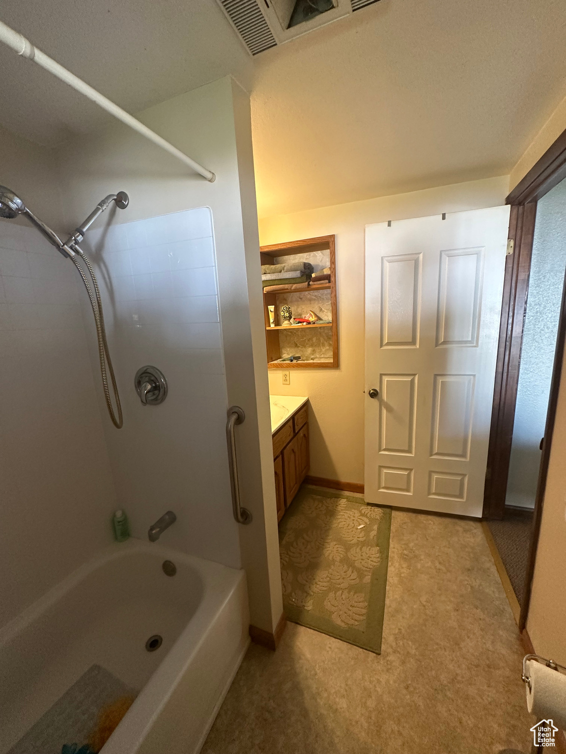 Bathroom featuring vanity and bathing tub / shower combination