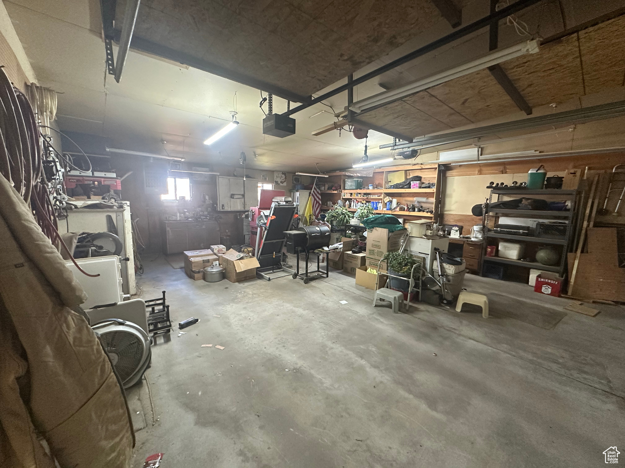 Garage featuring a garage door opener and a workshop area