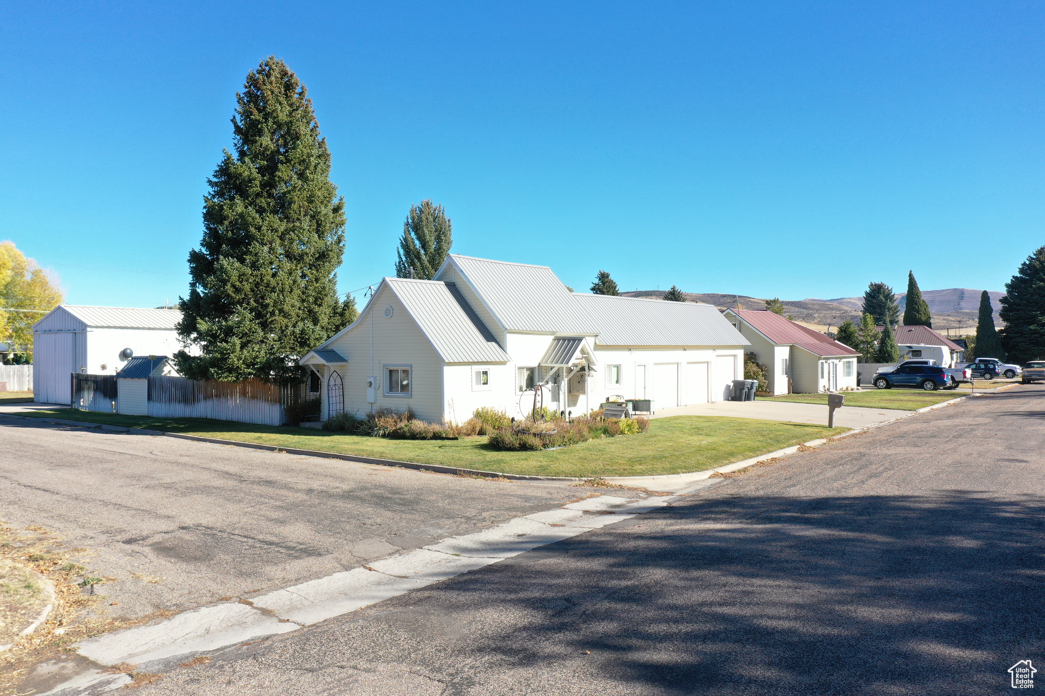 View of front of property featuring a garage and a front lawn