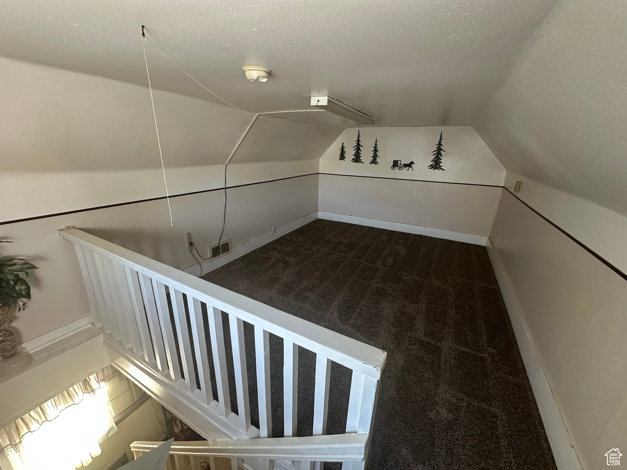 Bonus room with lofted ceiling, carpet floors, and a textured ceiling