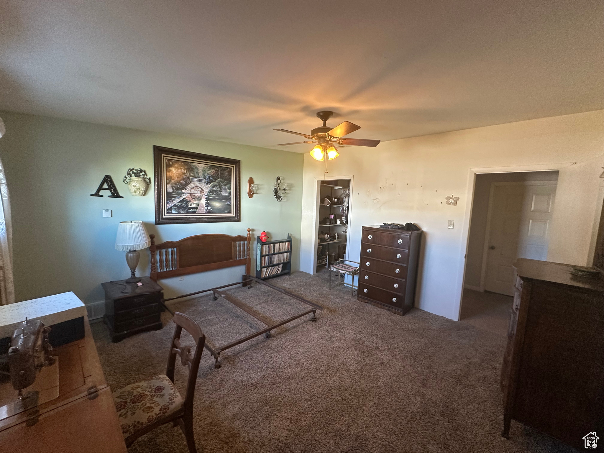 Carpeted bedroom featuring ceiling fan