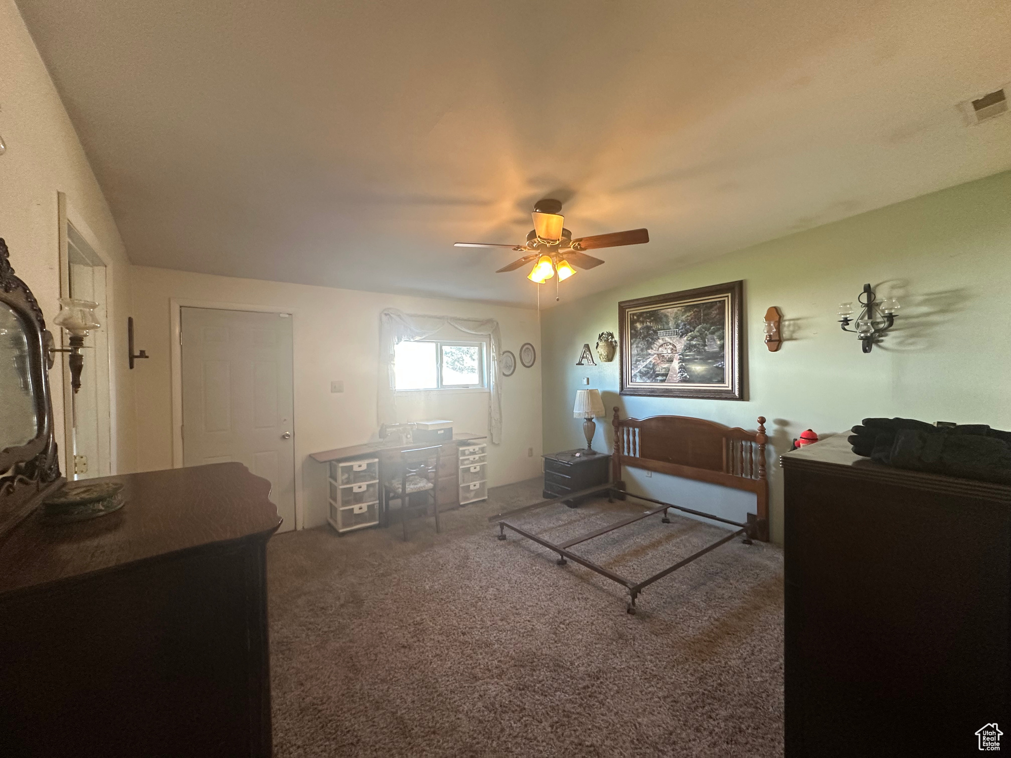 Living room featuring vaulted ceiling, dark carpet, and ceiling fan