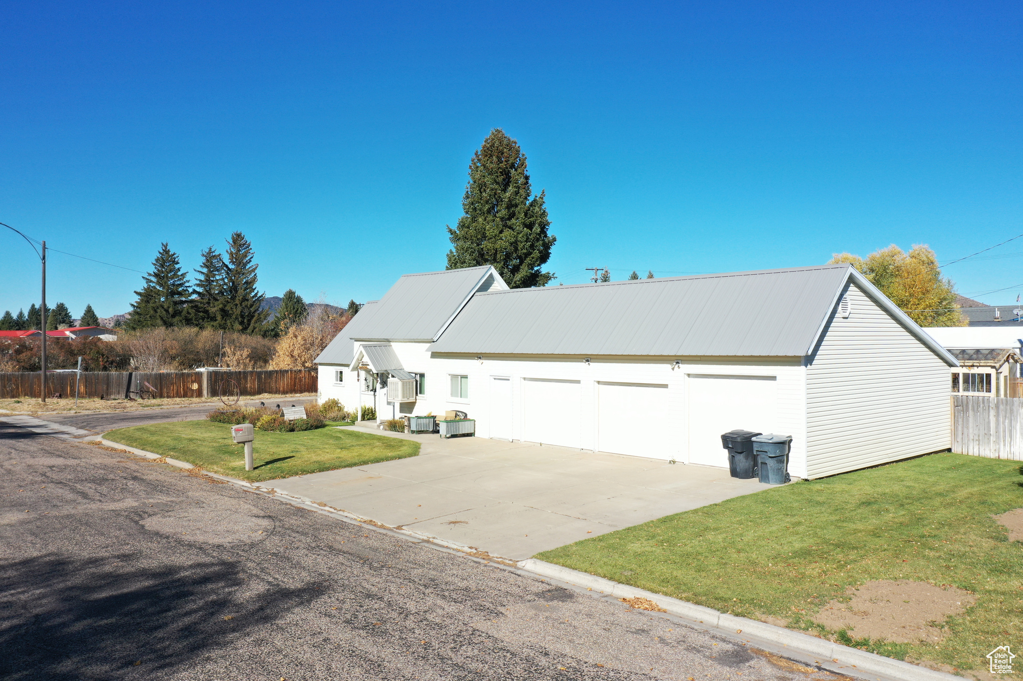 View of front of property featuring a front yard and a garage