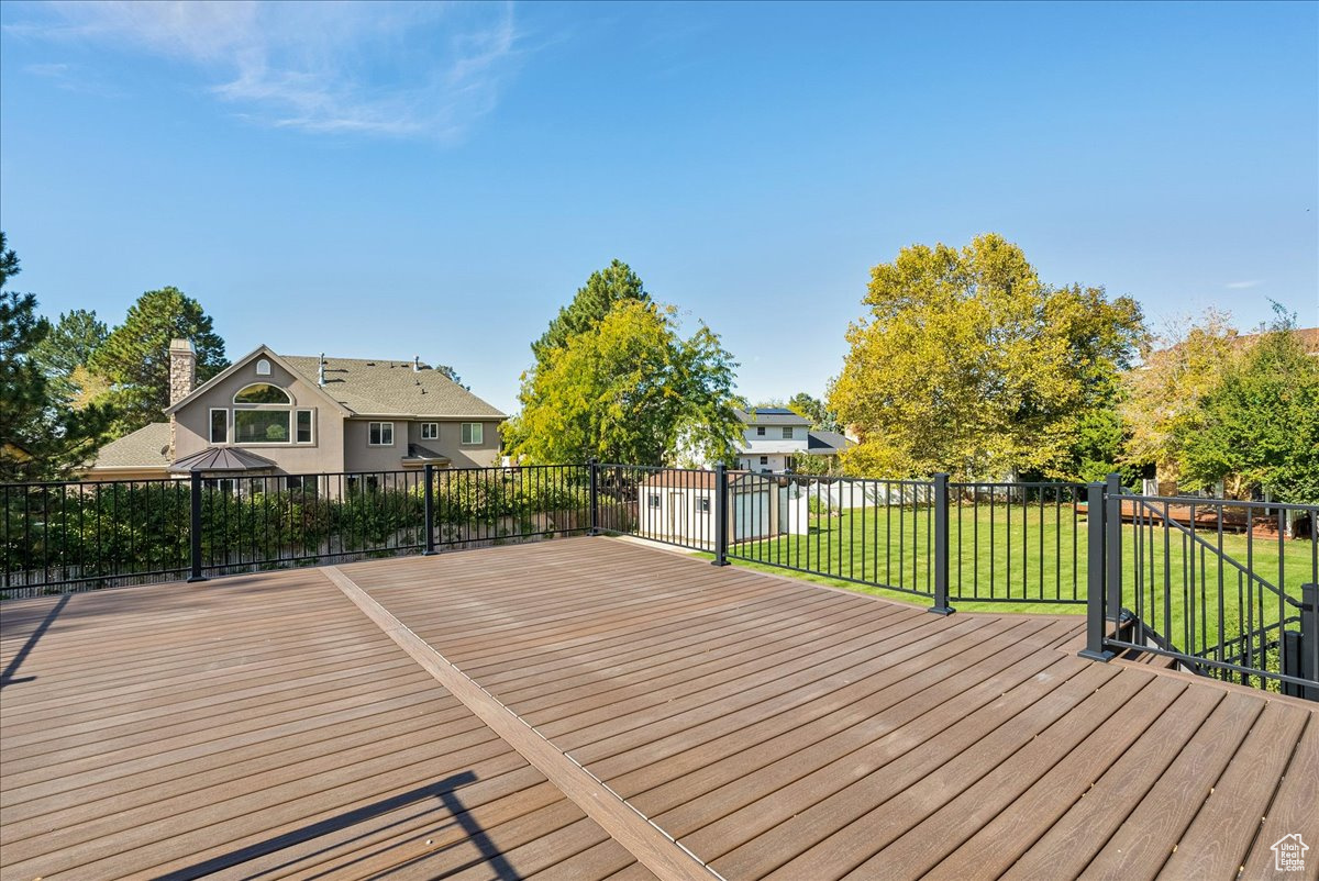 Wooden deck with a gazebo and a lawn