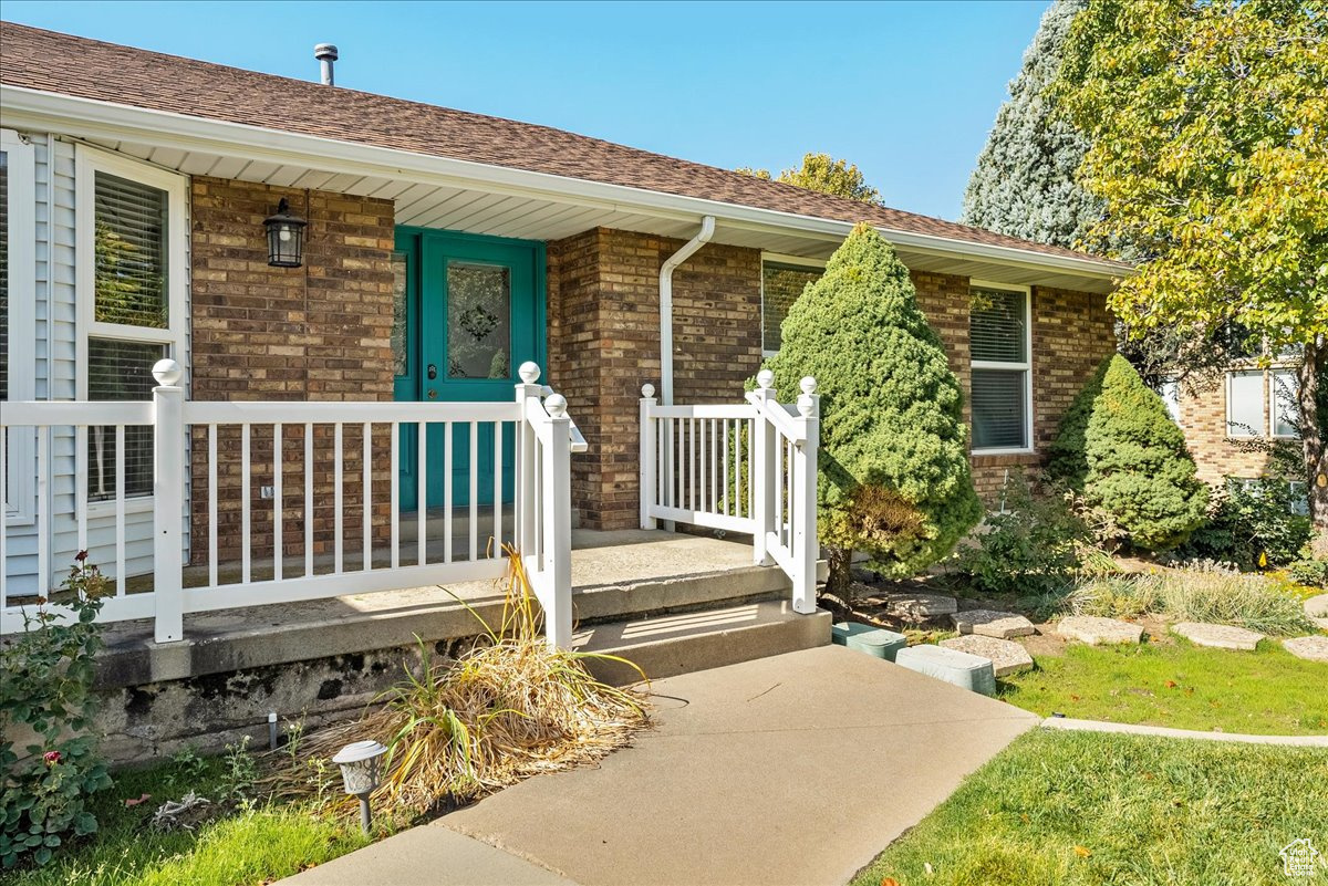 Entrance to property featuring covered porch