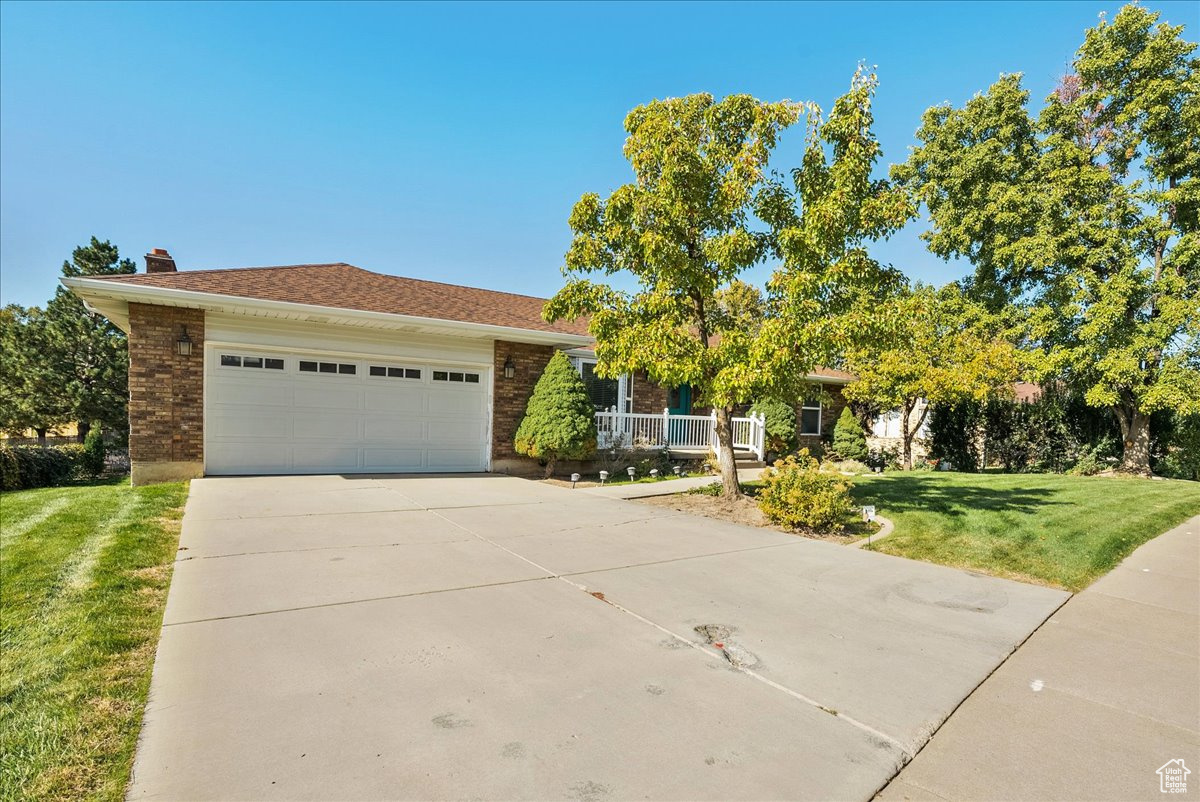 View of front of property with a front lawn and a garage