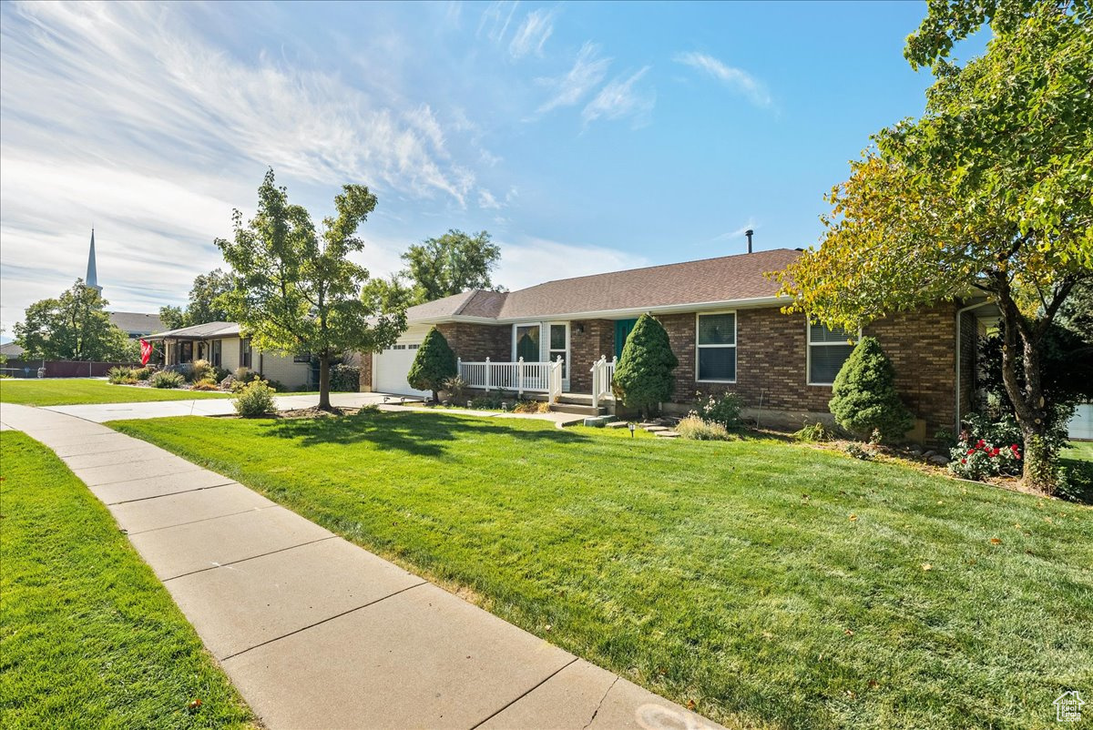 Ranch-style home with a front lawn