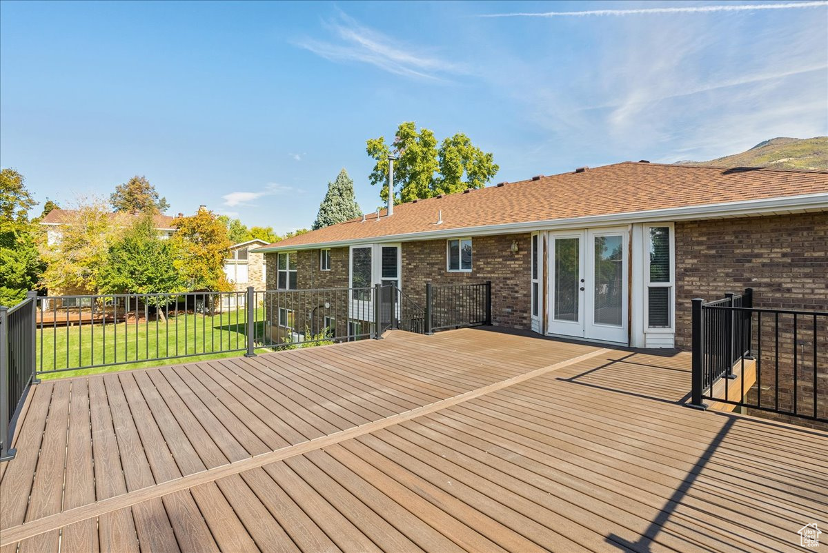 Wooden deck featuring a yard and french doors