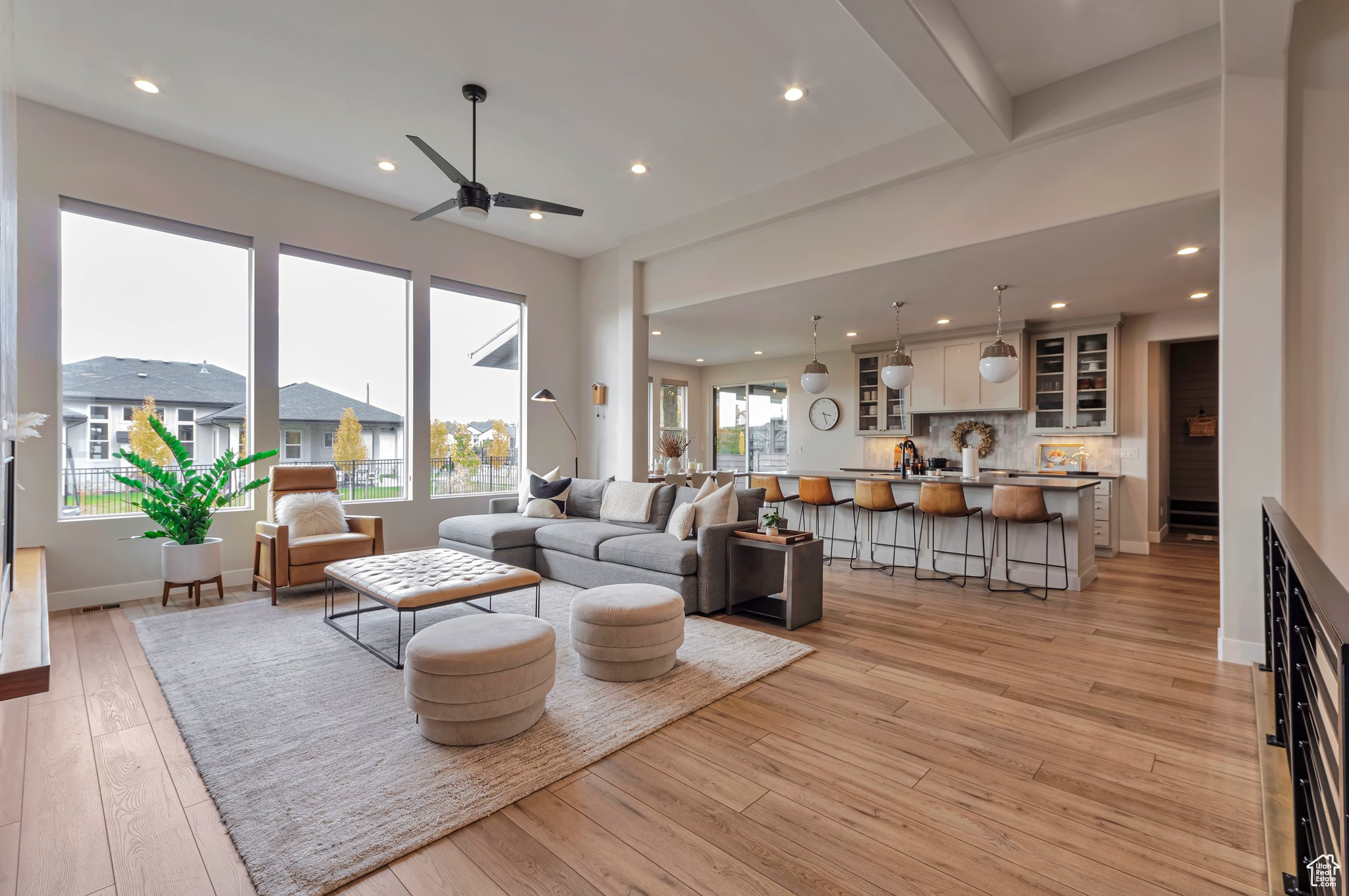 Living room with light hardwood / wood-style flooring, sink, and ceiling fan