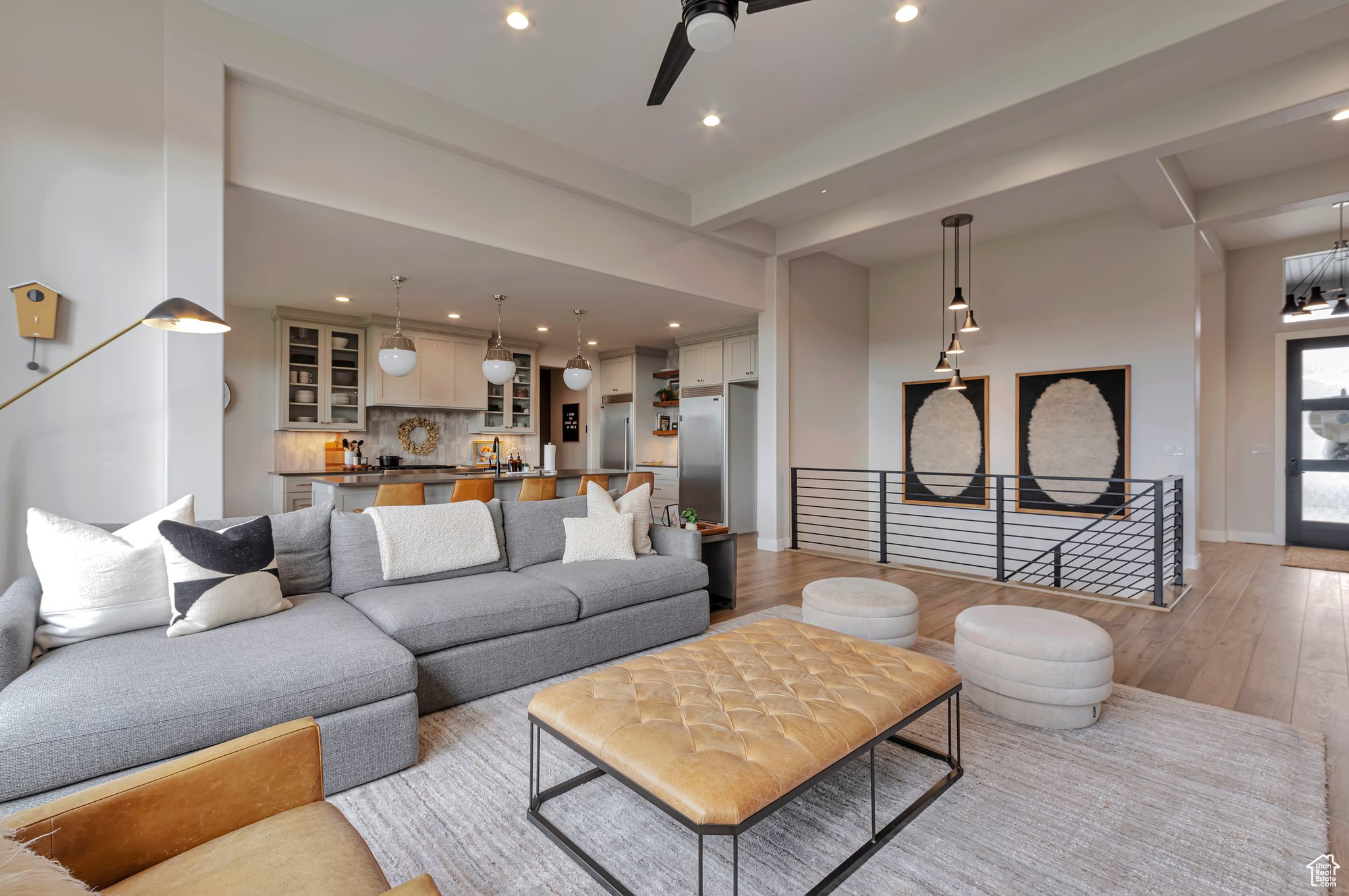 Living room with light wood-type flooring and ceiling fan