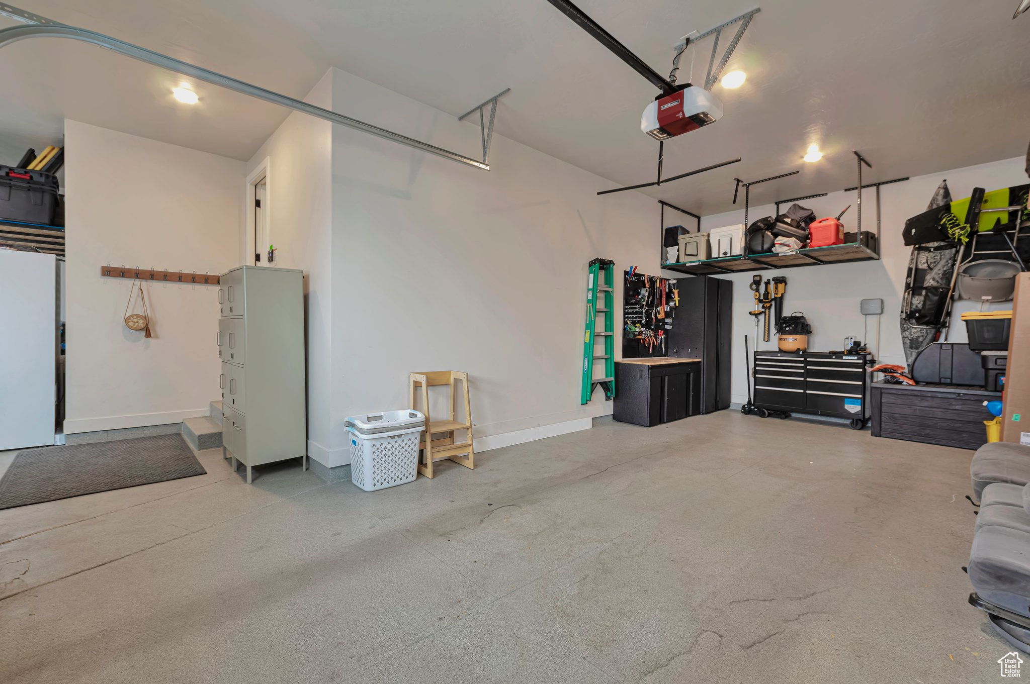 Fully Finished Garage featuring a garage door opener