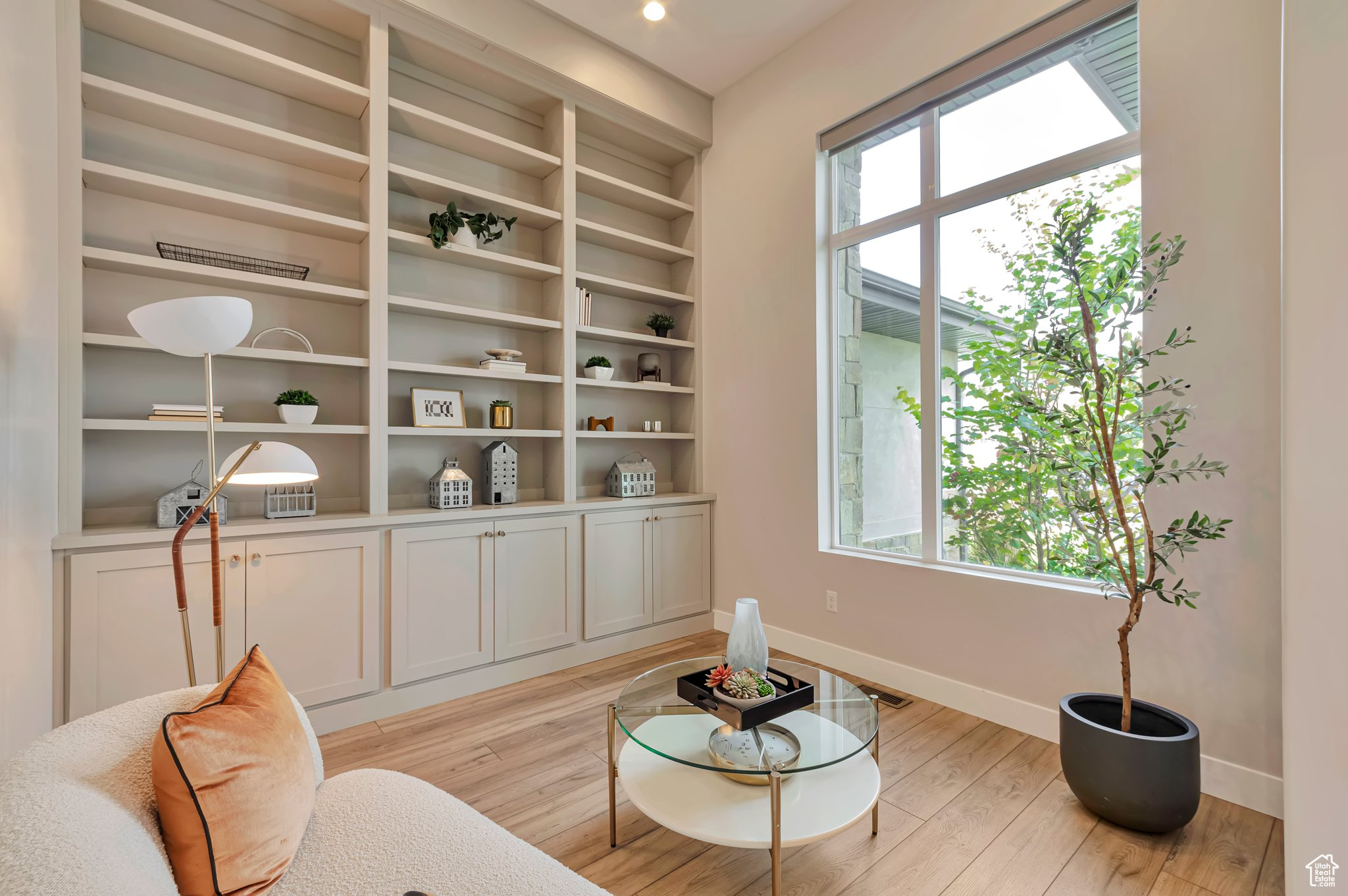 Living area featuring light wood-type flooring and a wealth of natural light