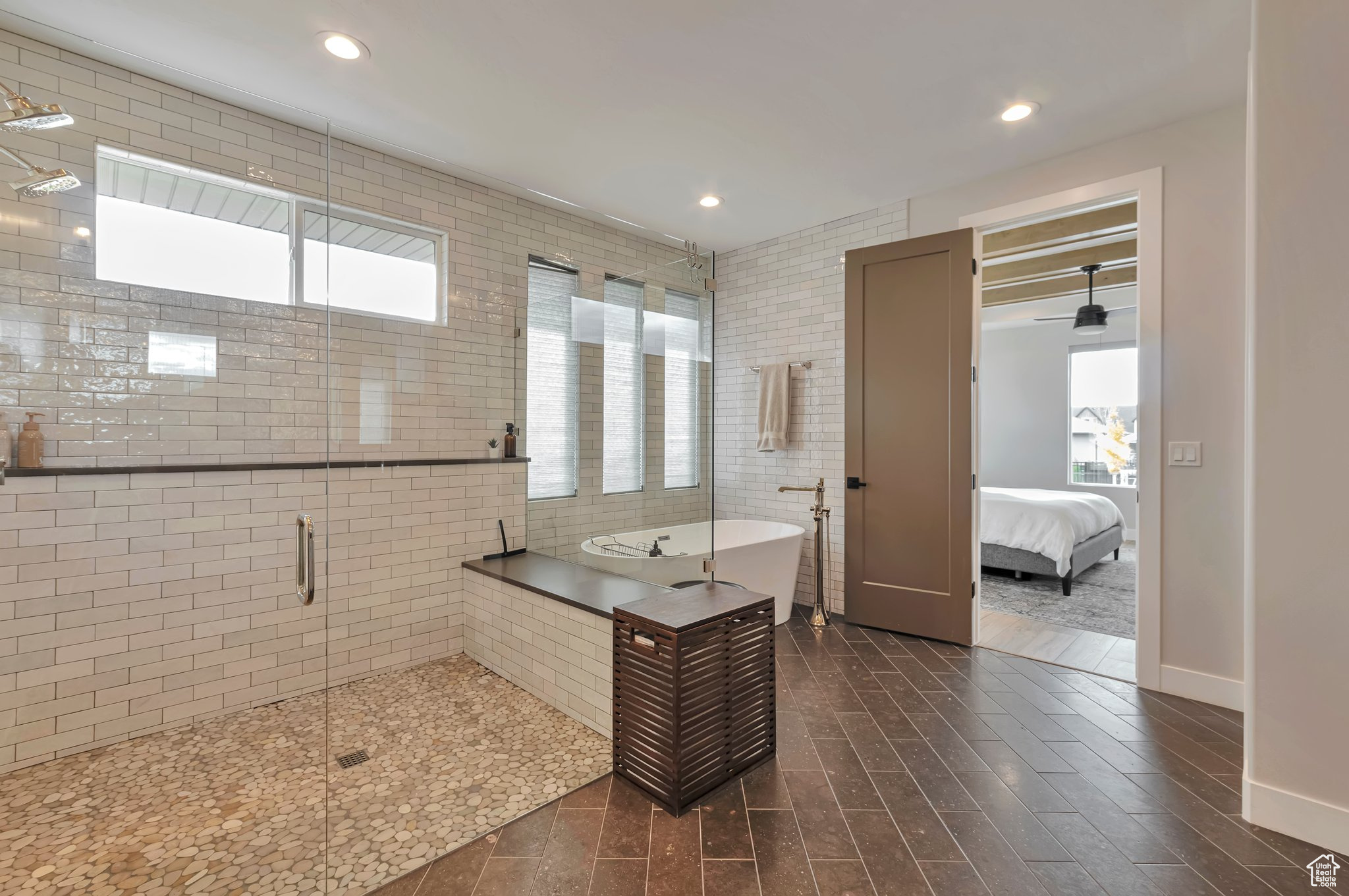 Bathroom with separate shower and tub, wood-type flooring, plenty of natural light, and tile walls