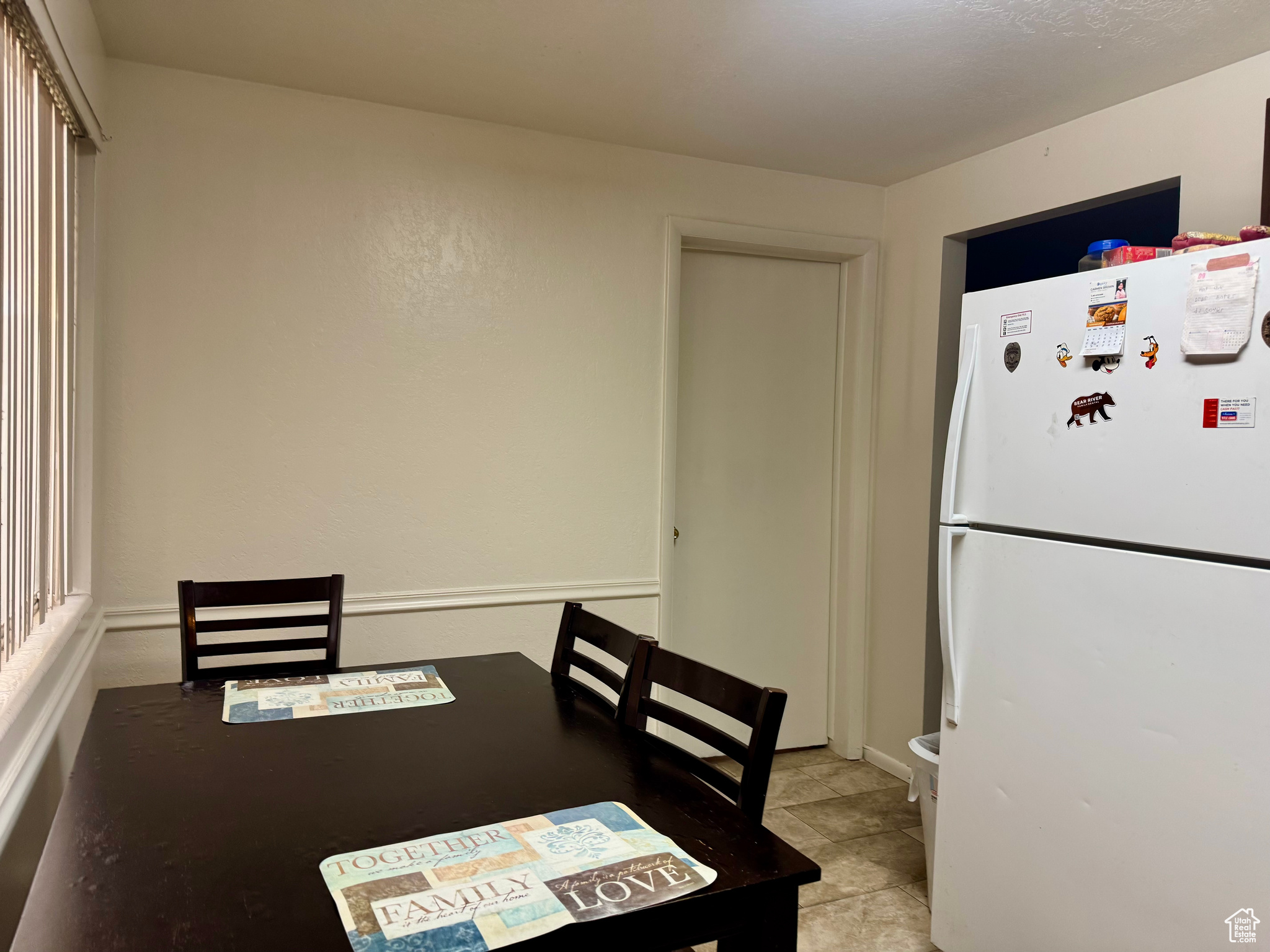 Dining space featuring light tile patterned flooring