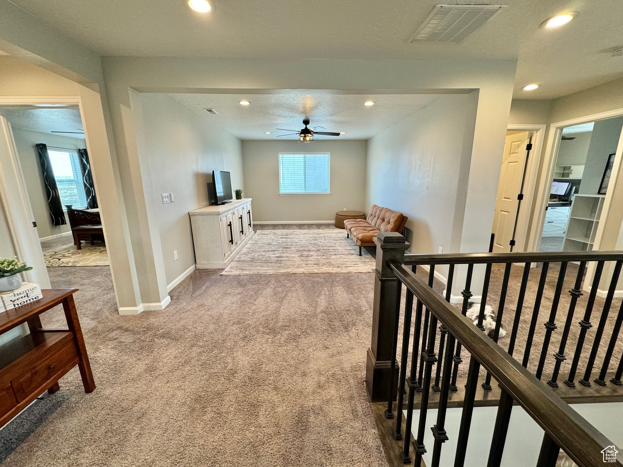 Upstairs Landing. Corridor with carpet, a textured ceiling, and plenty of natural light